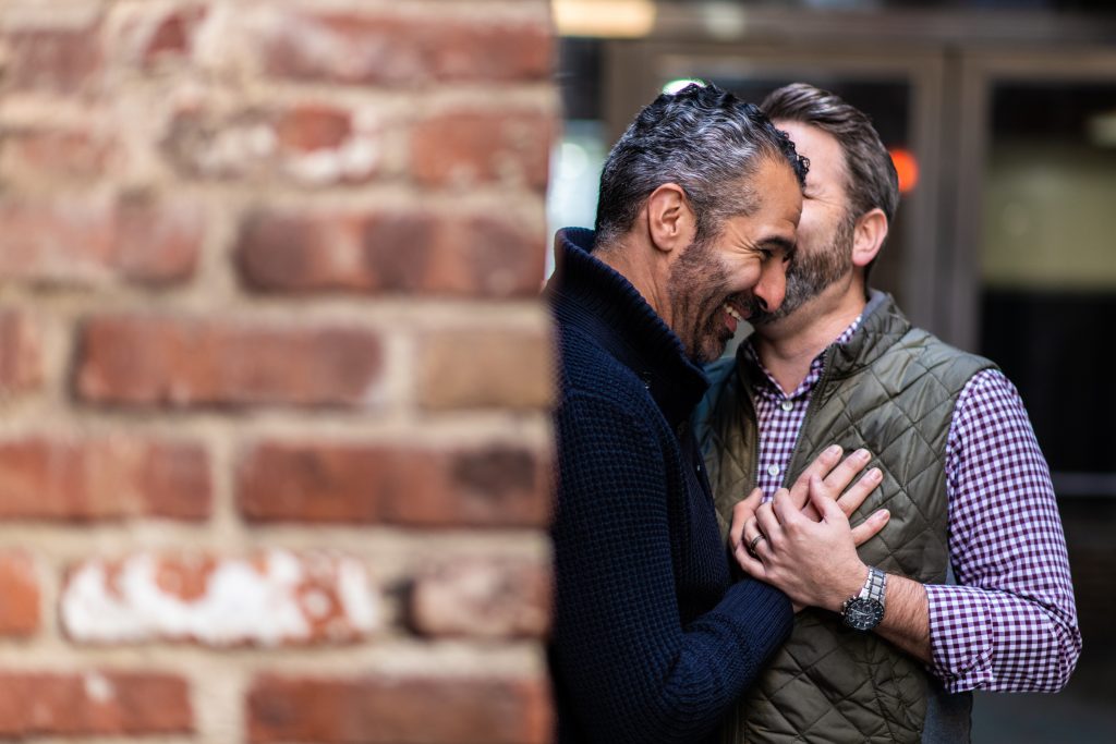 lgbtq couple sharing a secret in downtown nyc